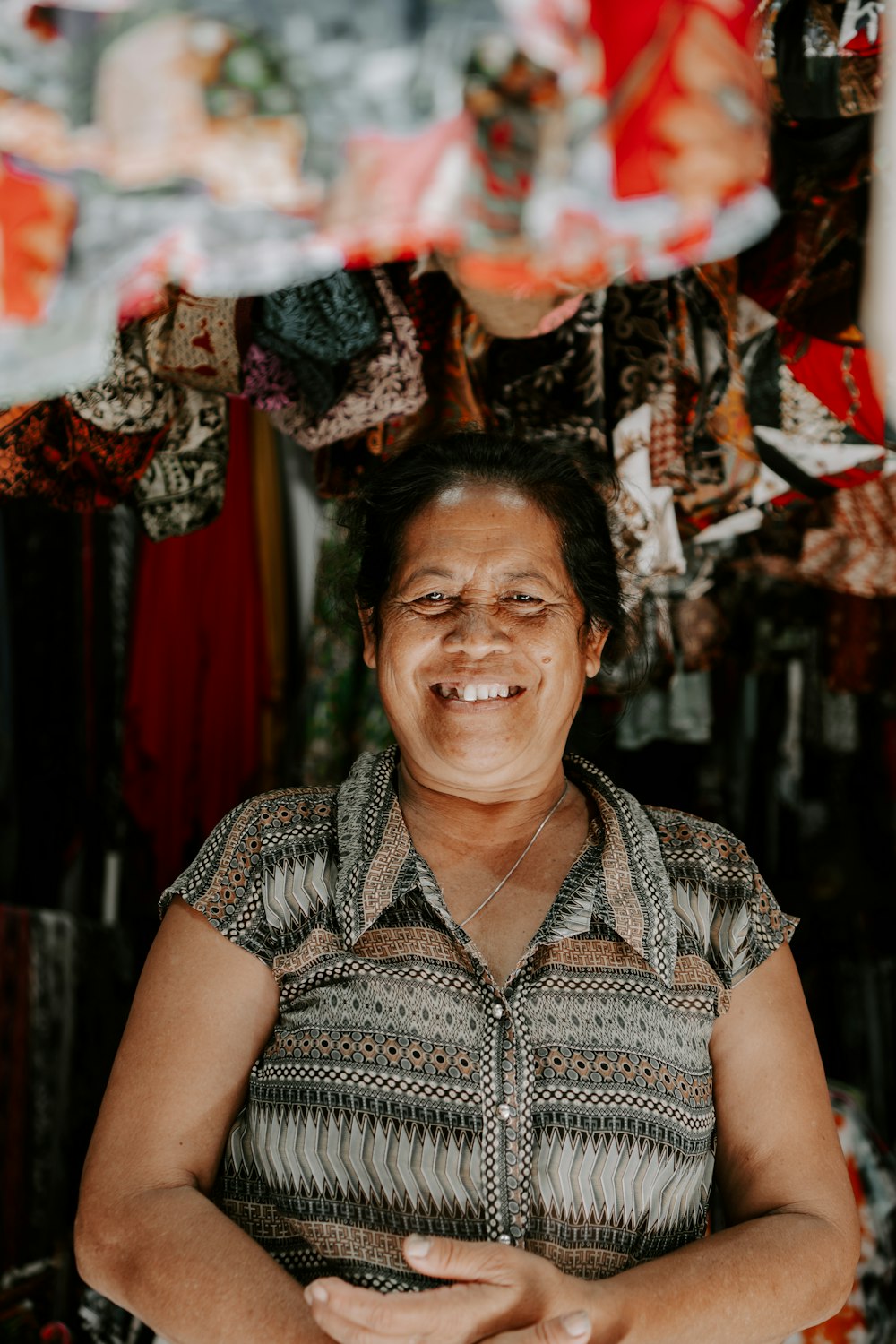 a person smiling with the hands clasped