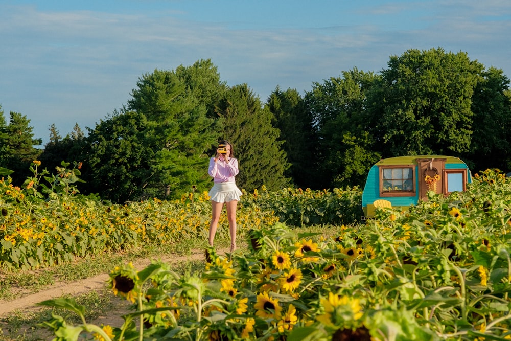 a person standing in a field of flowers