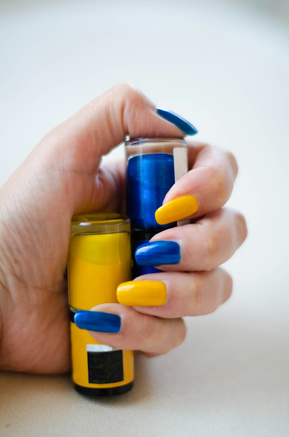 a person holding a jar of nail polish