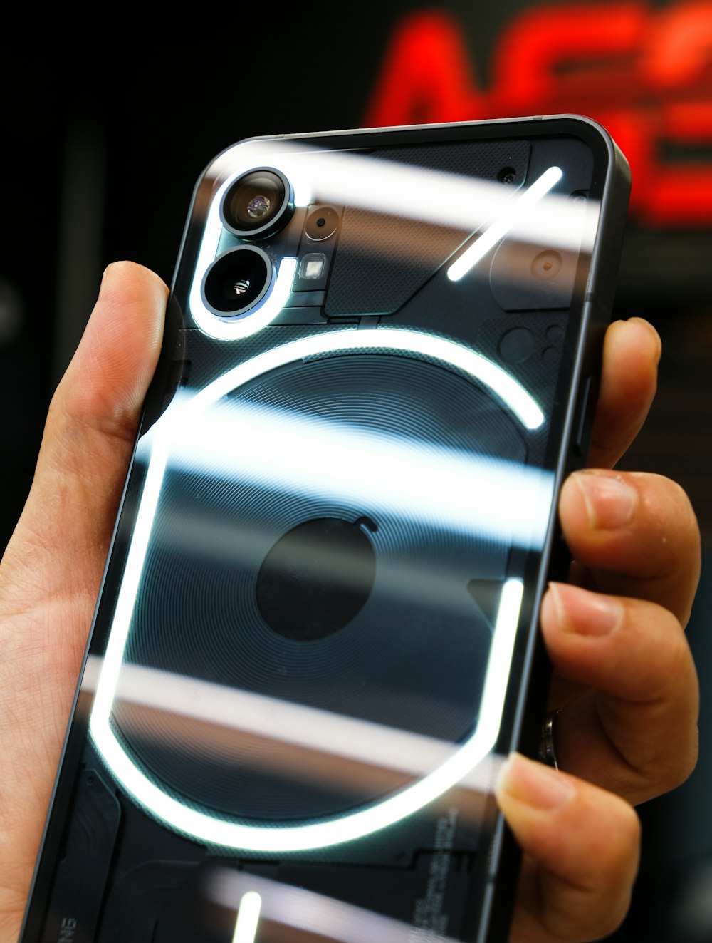 a hand holding a silver and black cell phone