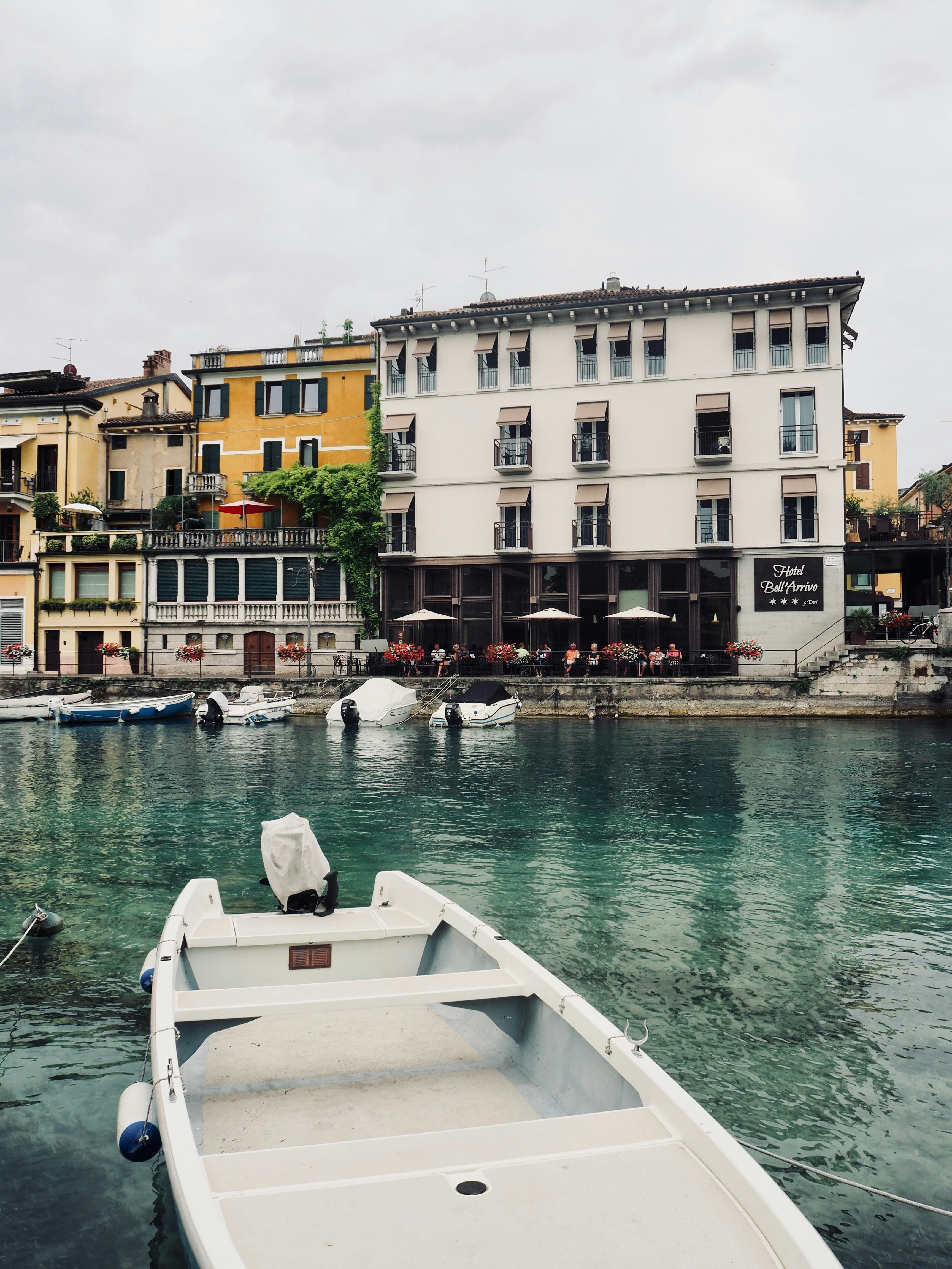 a group of boats in a body of water with buildings around it