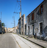 A desolate street scene with crumbling buildings and scattered debris.