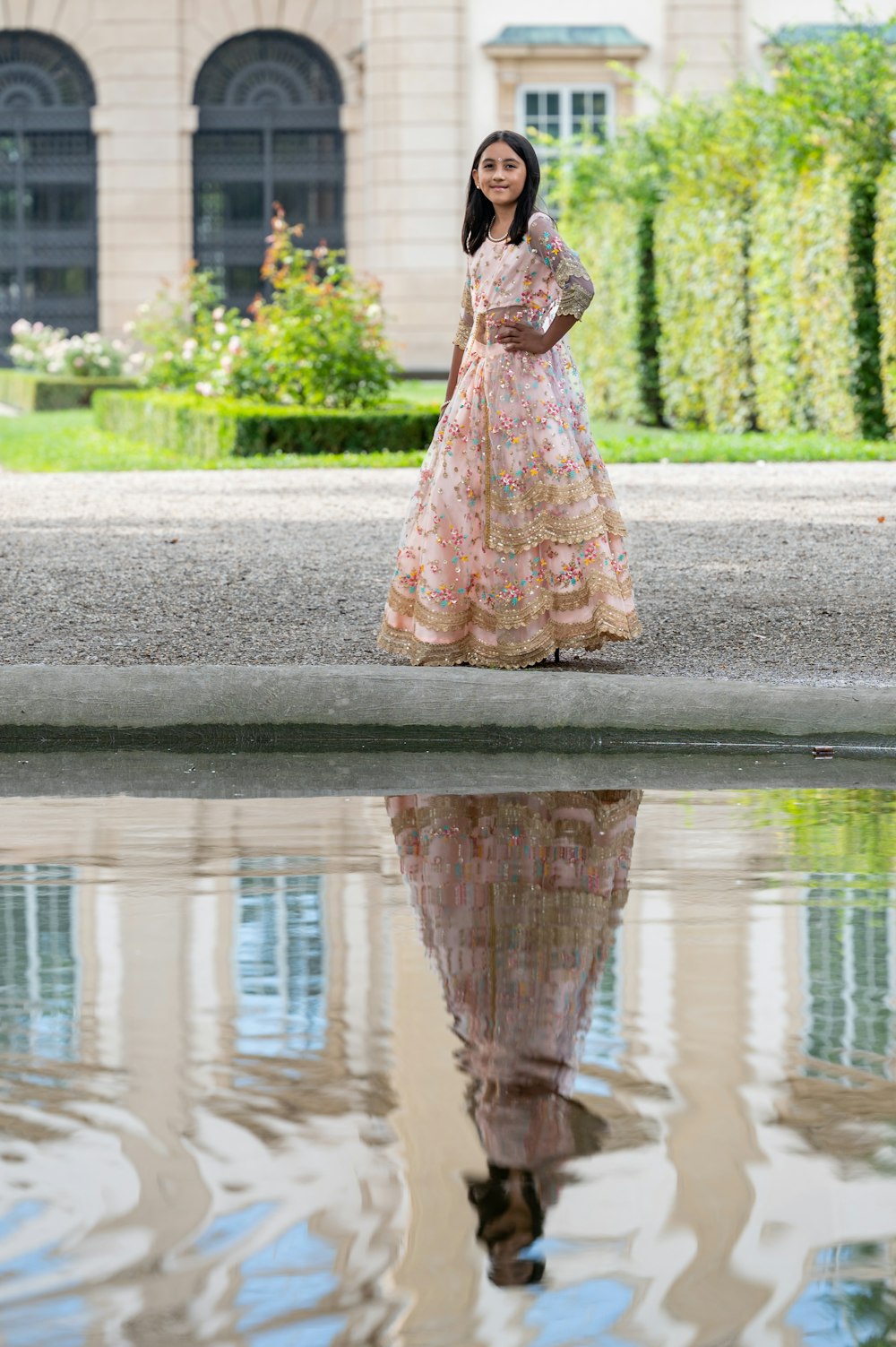 a person in a dress standing in a fountain