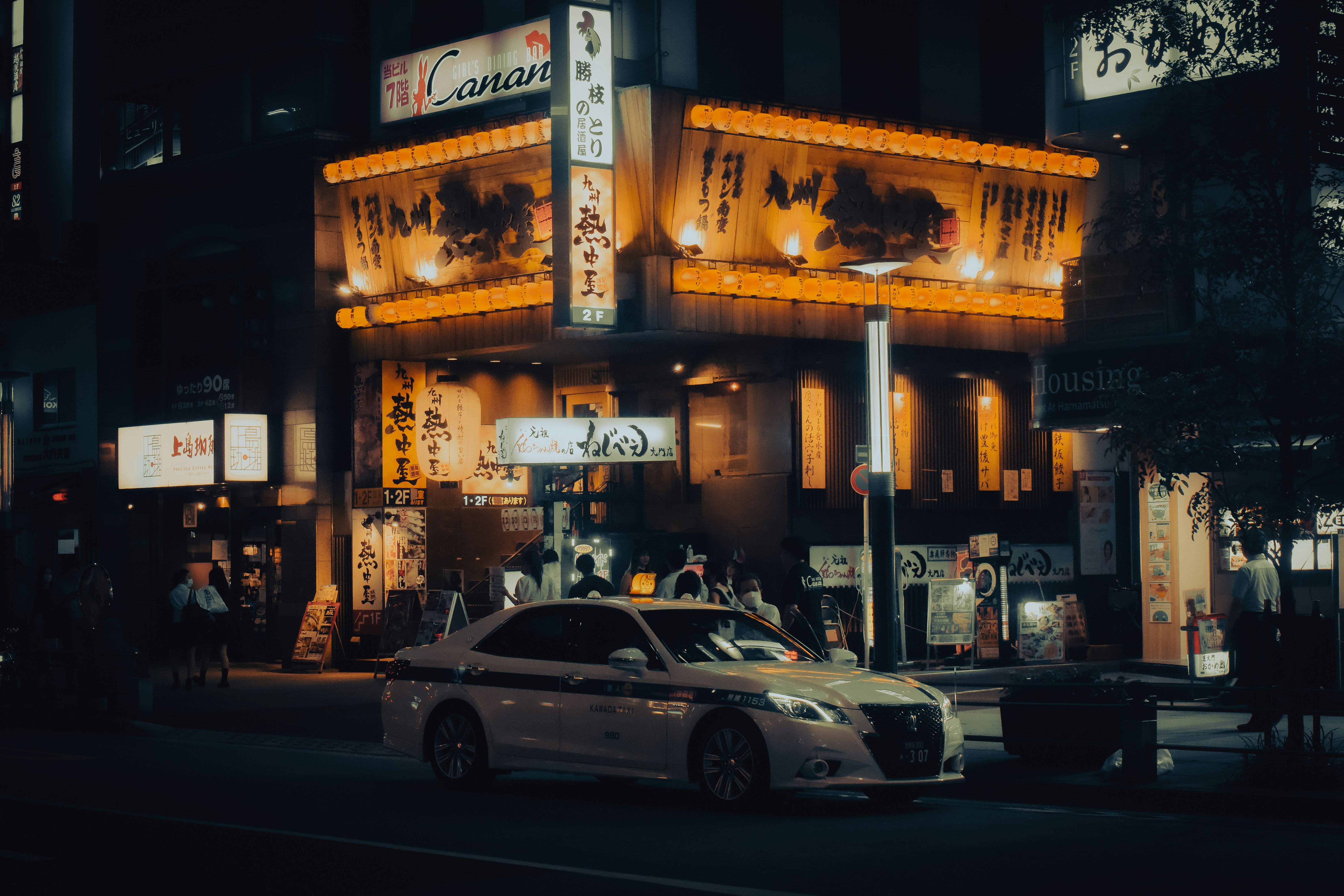 a car parked in front of a building with signs on it