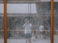 a group of people standing in front of a wall with graffiti