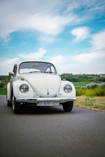 A well-maintained classic car parked on a charming UK village street under soft daylight.