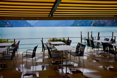 A sunlit garden terrace at Sterling Ooty with blooming flowers and seating.