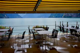 Outdoor terrace with tables overlooking Zugersee and surrounding mountains.