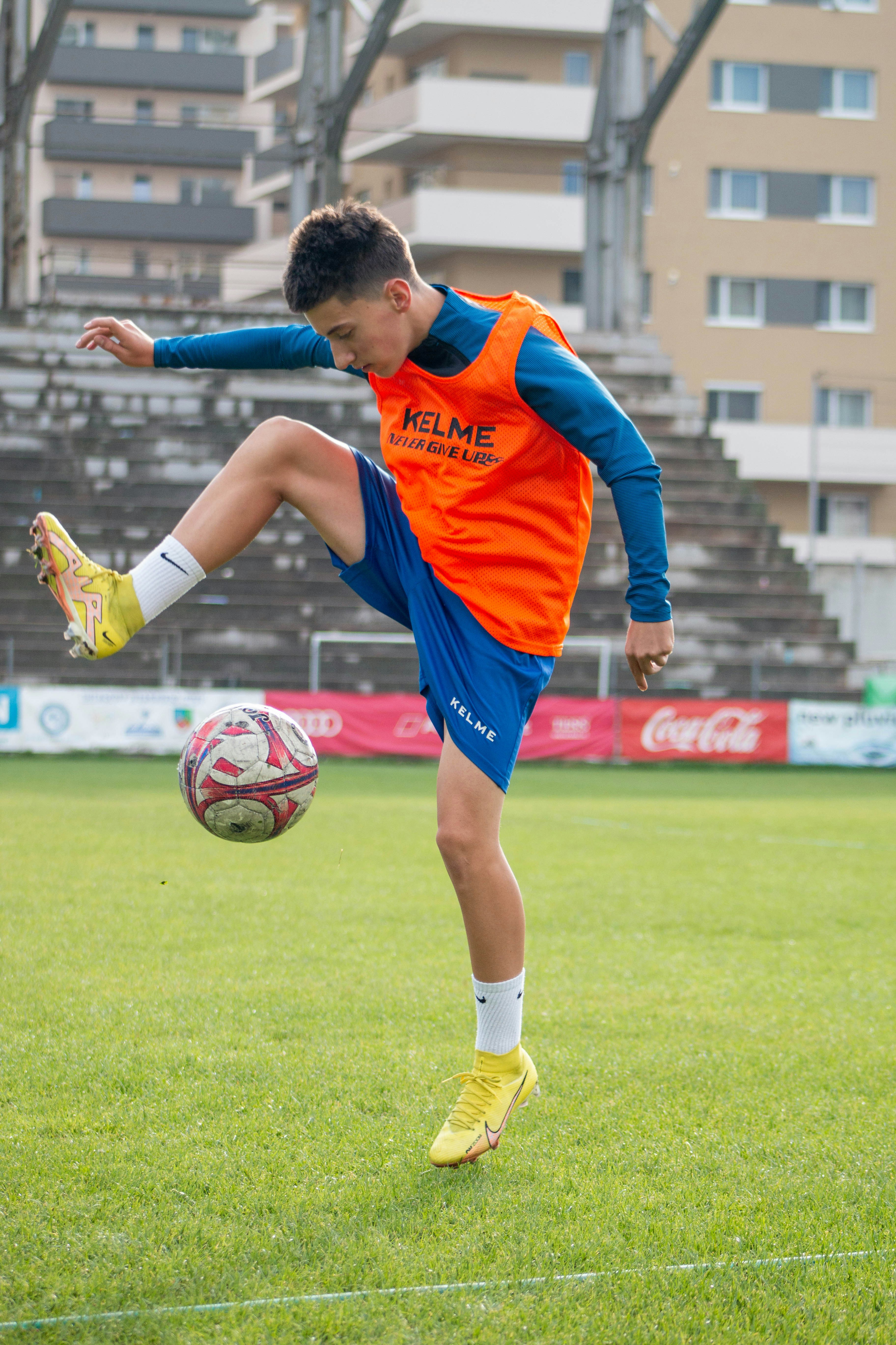 a man kicking a football ball