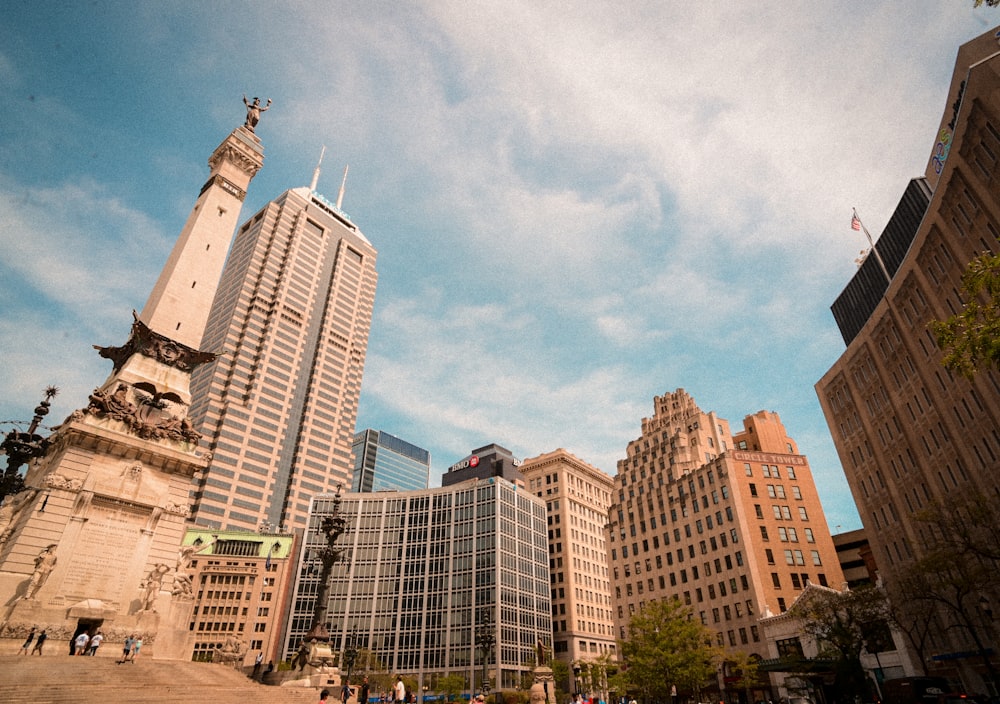 a group of buildings with a statue on top