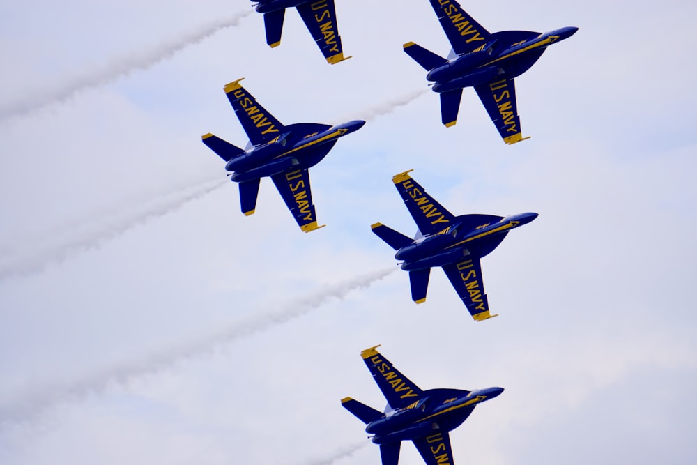 a group of blue airplanes flying in the sky