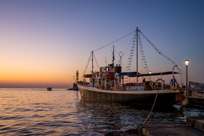 A center console boat docked with a soft sunset casting warm hues over the deck.