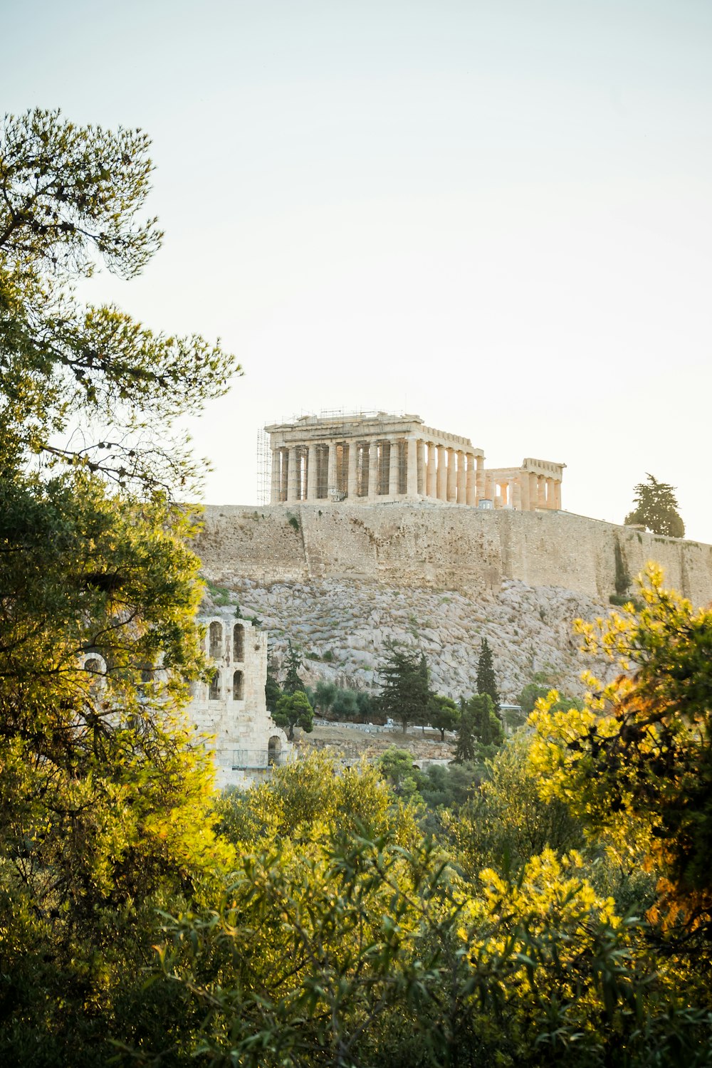 a large stone building on a hill