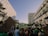 A crowd of people gathered between tall buildings, holding signs with slogans such as 'Abort Alito' and 'Overturn Roe? Hell No!' in a protest. The scene captures a mixture of emotions as people advocate and express their views.