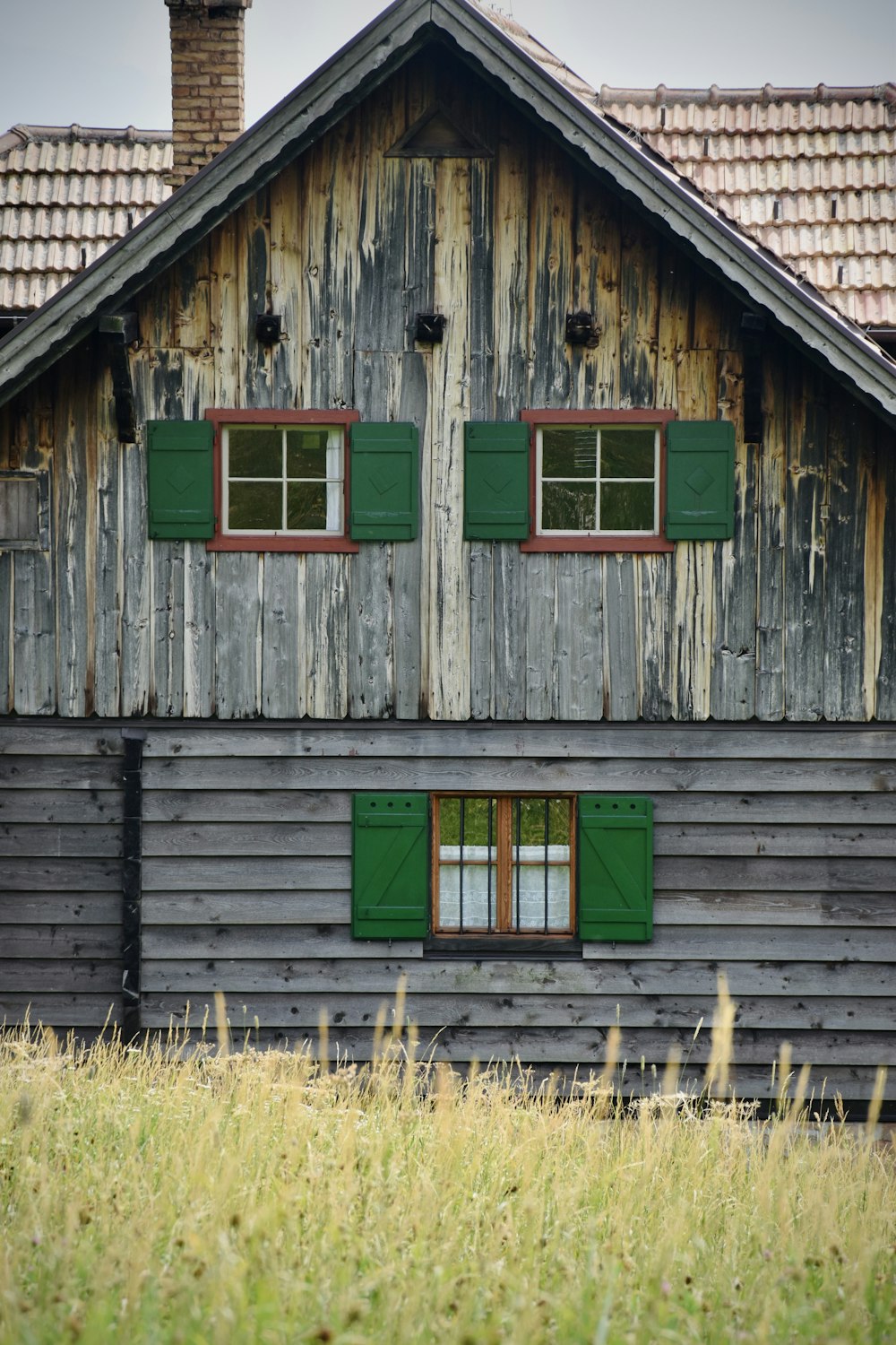 a wooden house with green shutters