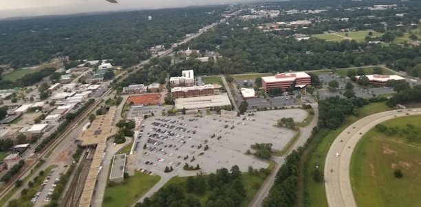 Suburban strip mall with several storefronts and ample parking.