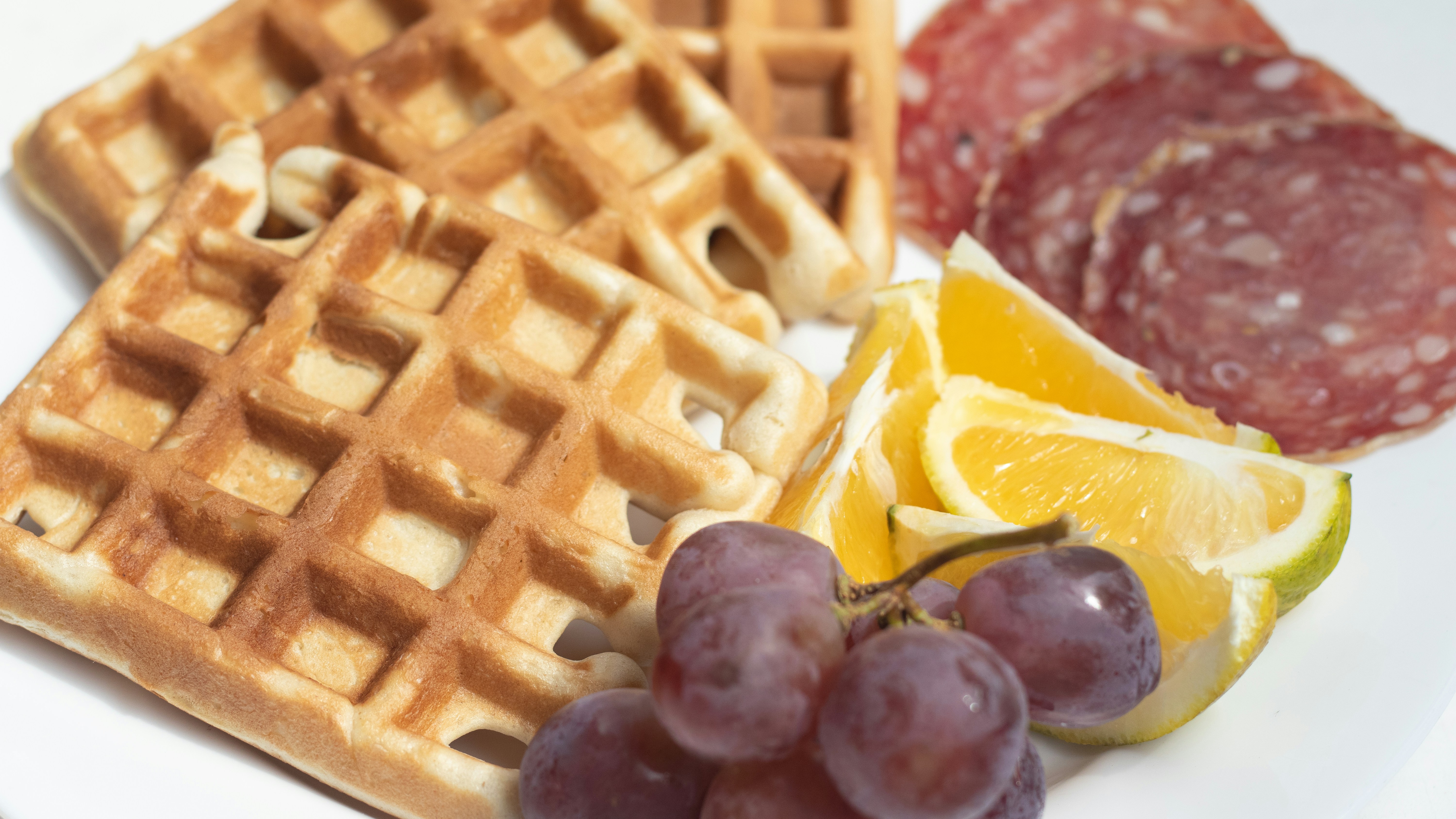 Waffles with grapes, lemon and salami