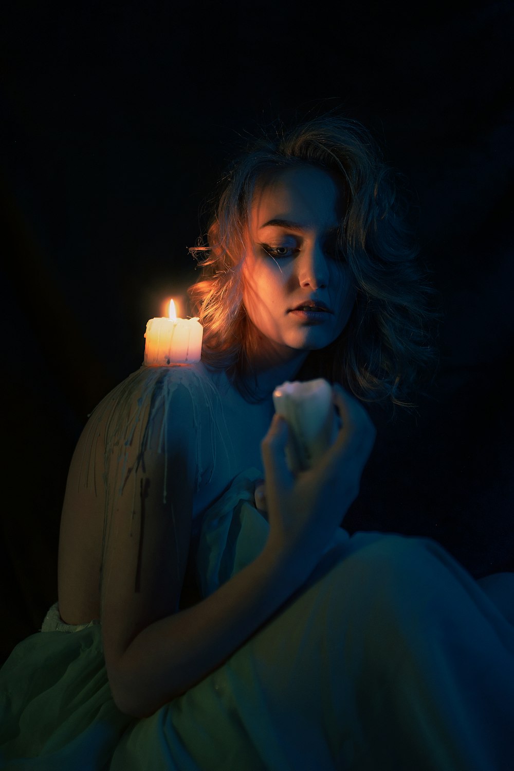 a woman holding a candle