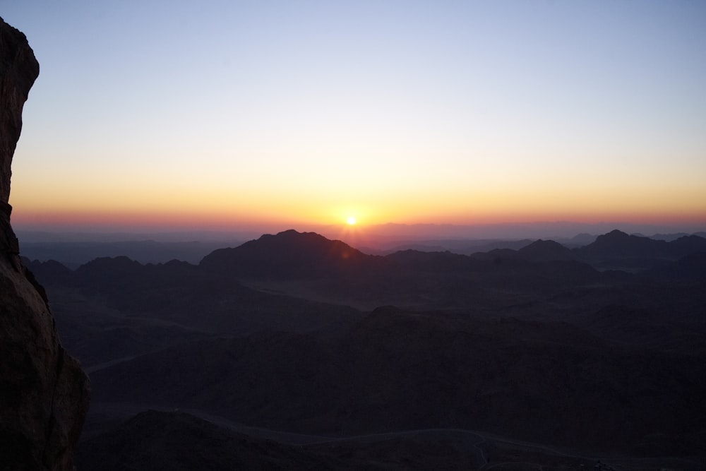 a sunset over a mountain range