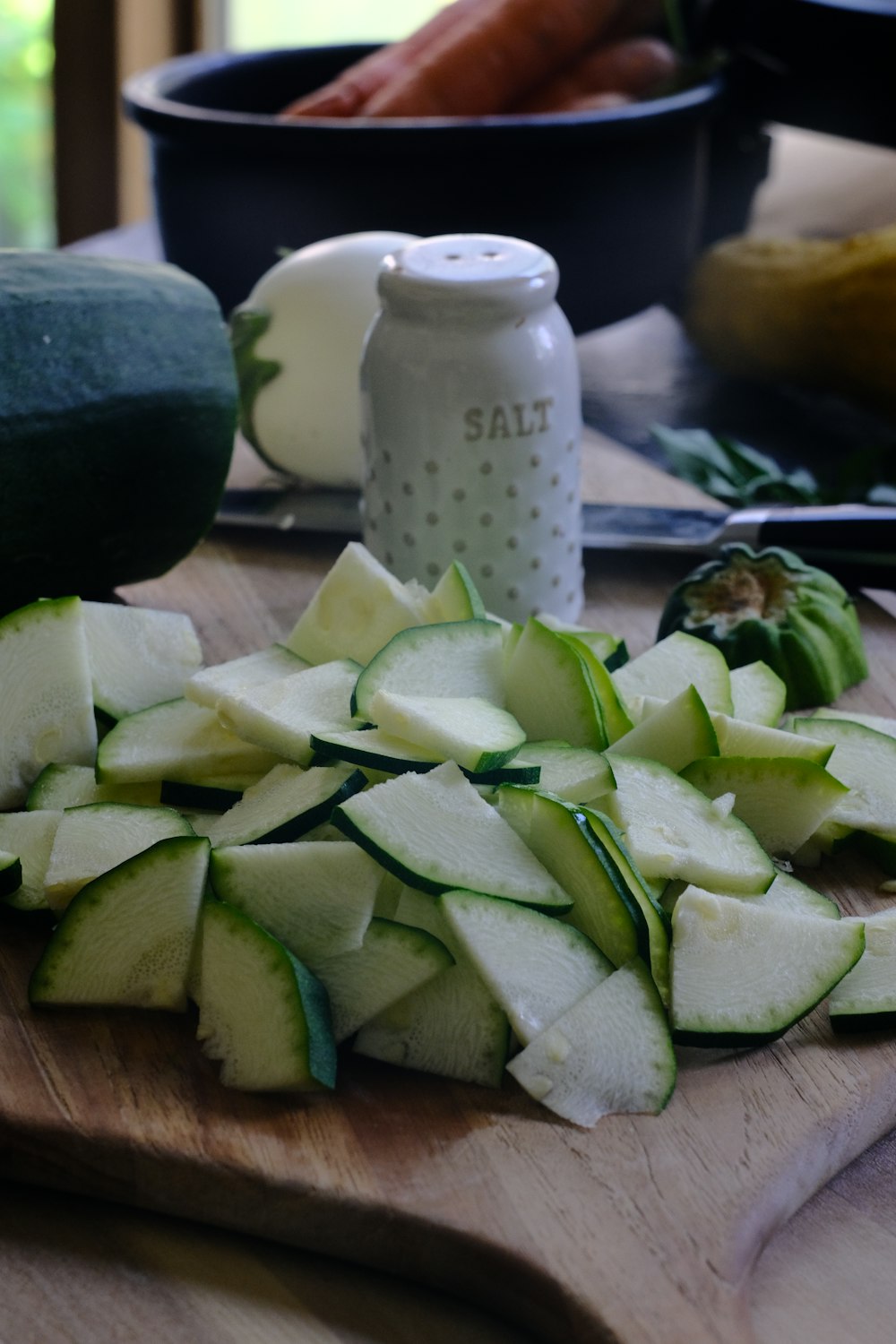 a board with sliced vegetables on it