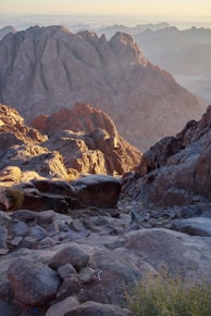 a rocky mountain with a valley below