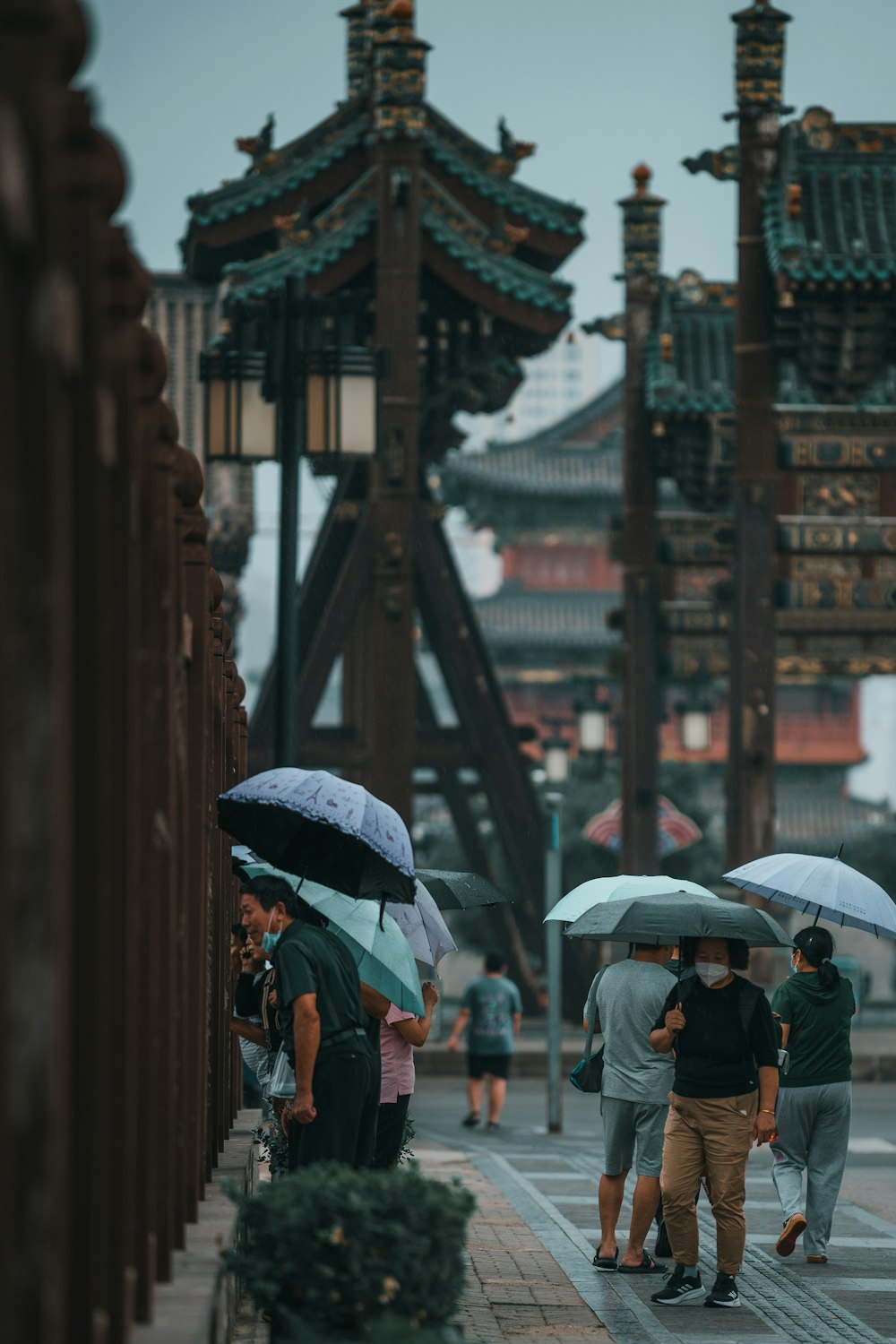 people walking under umbrellas