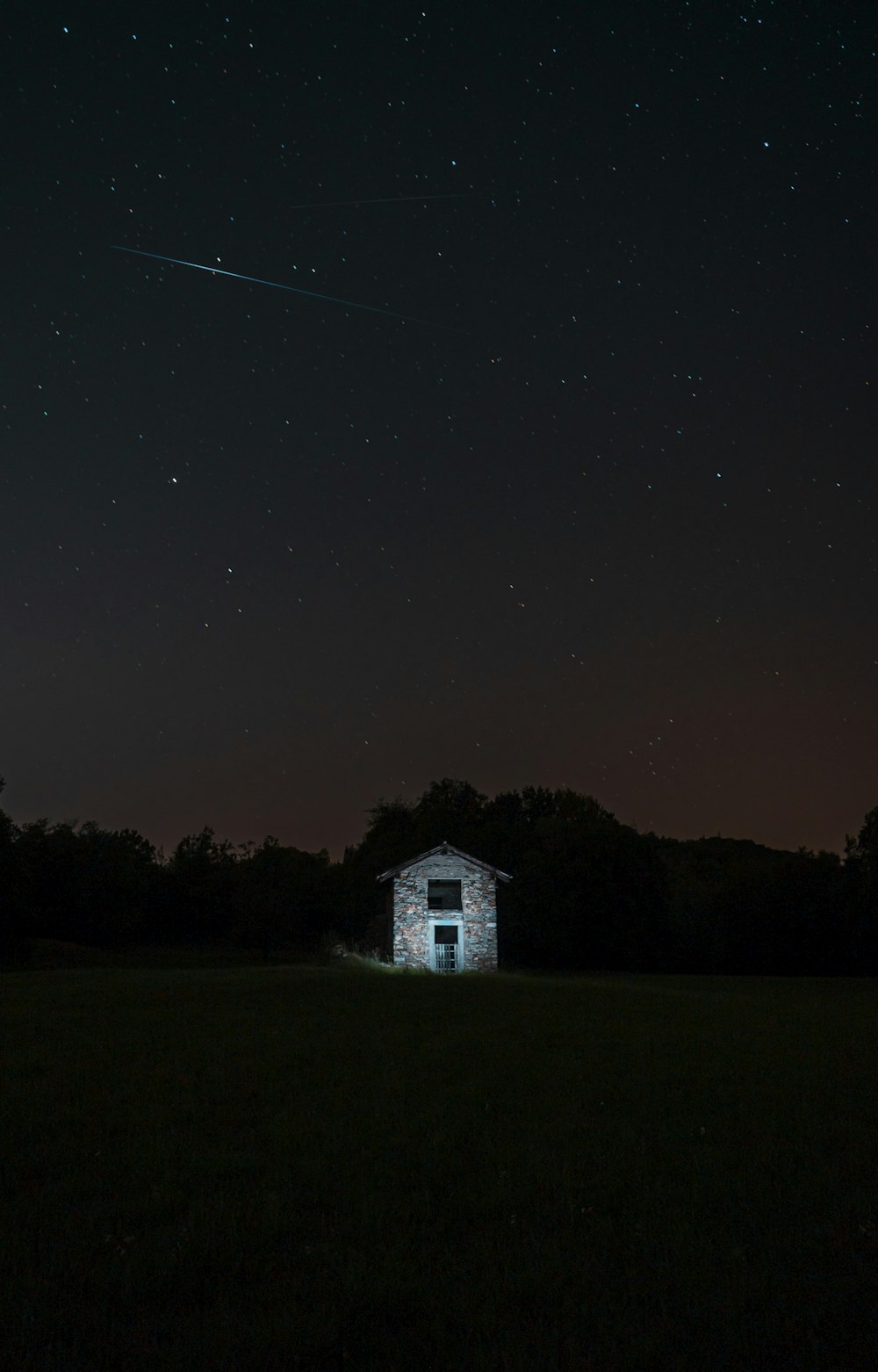 a small house under a starry sky