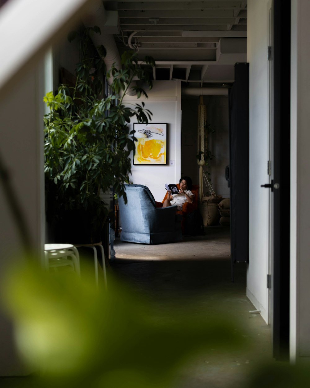 a man and woman sitting on a couch in a hallway