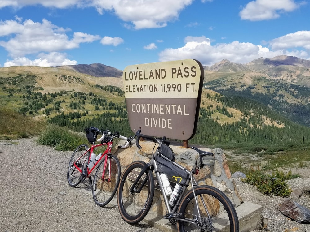 bicycles parked next to a sign