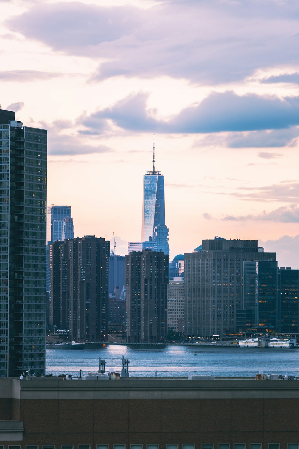 a city skyline with a body of water in the foreground