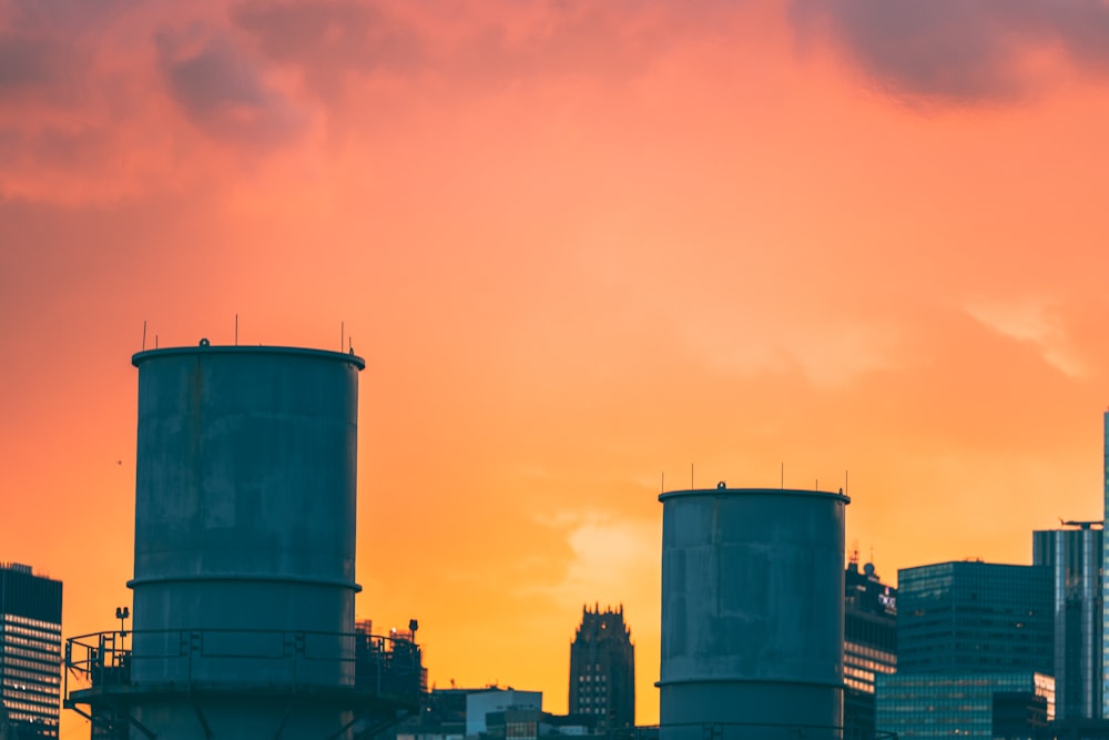 a group of buildings with a pink and blue sky