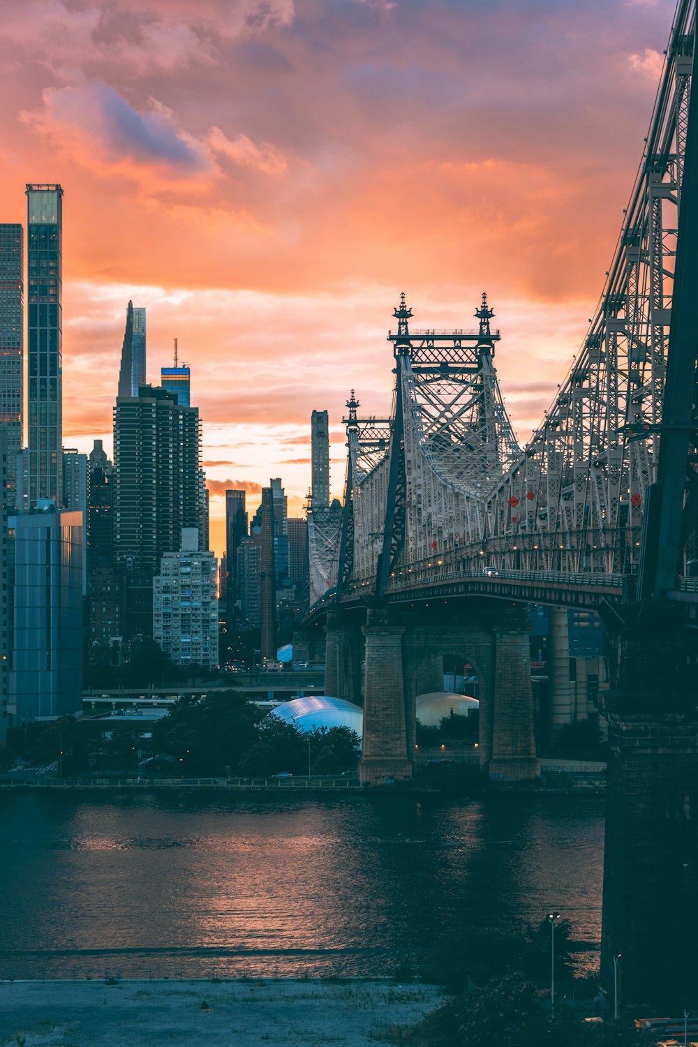 a bridge over water with buildings in the background