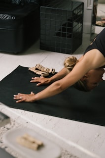 a woman lying on the floor with a model of a house