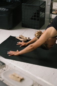 a woman lying on the floor with a model of a house