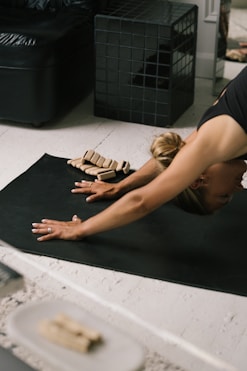 a woman lying on the floor with a model of a house