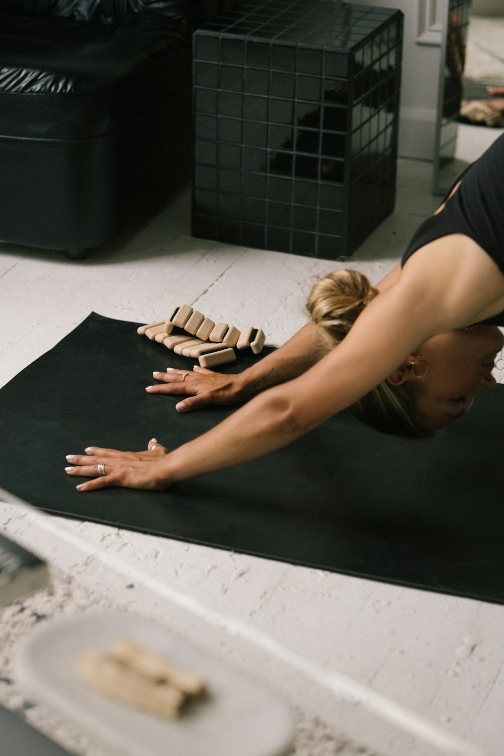 a woman lying on the floor with a model of a house