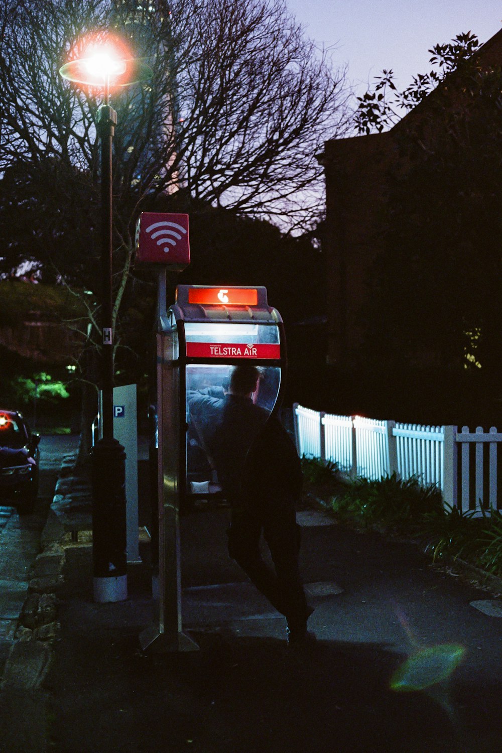 a person standing next to a bus stop