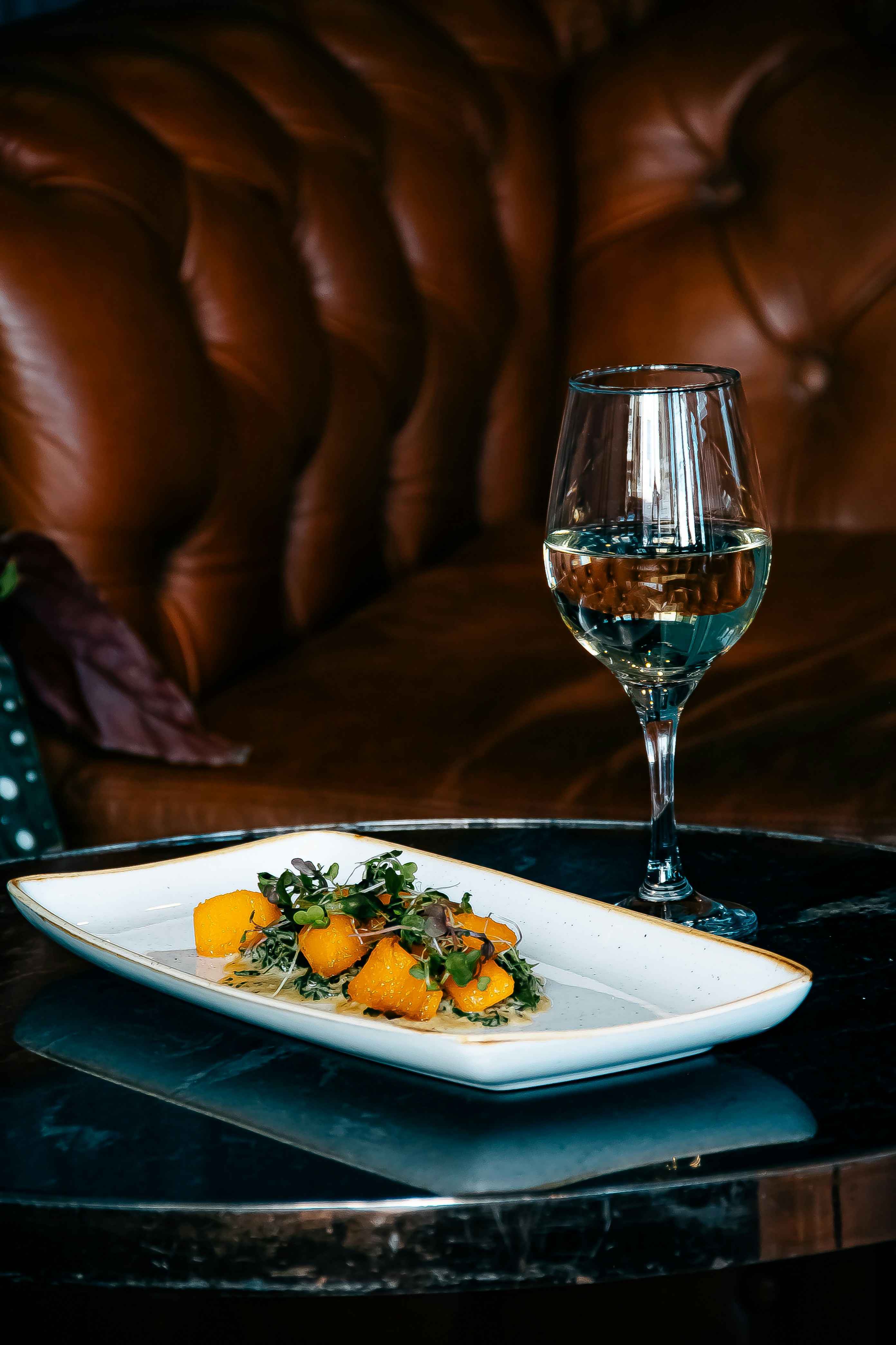 a plate of food and a glass of wine on a table