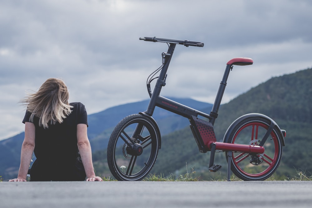 a woman looking at a bicycle