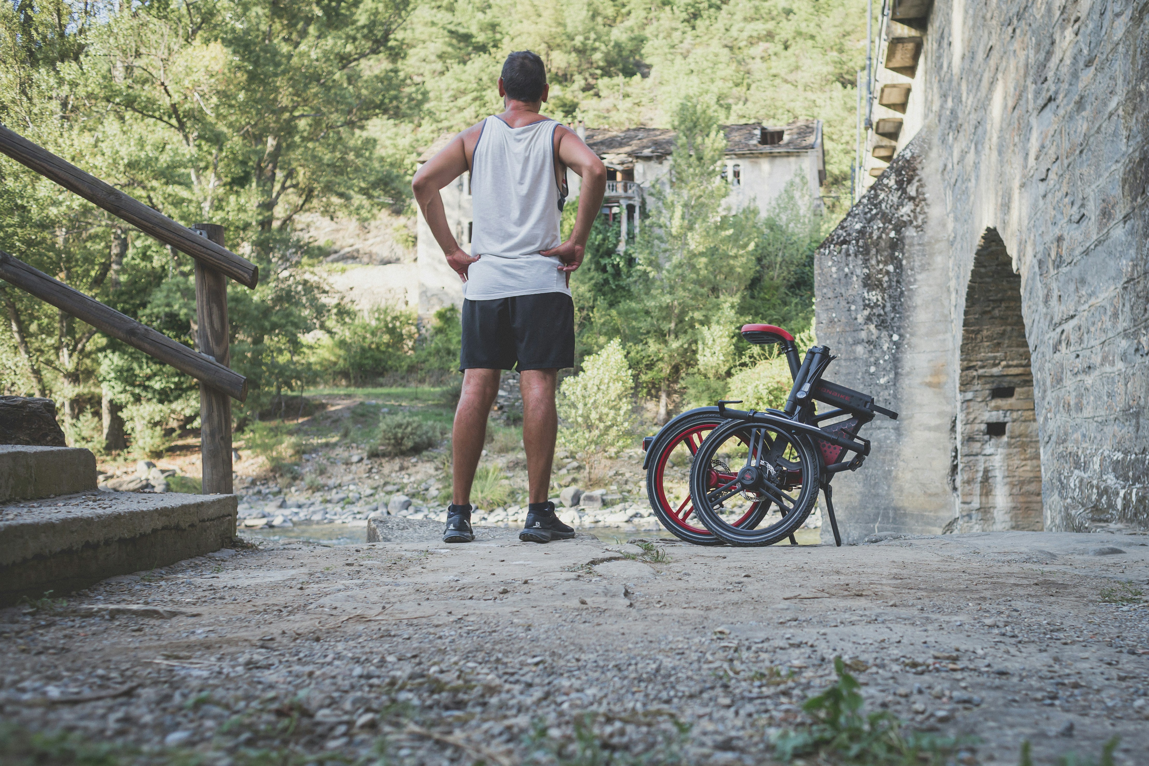 a man standing next to a bicycle