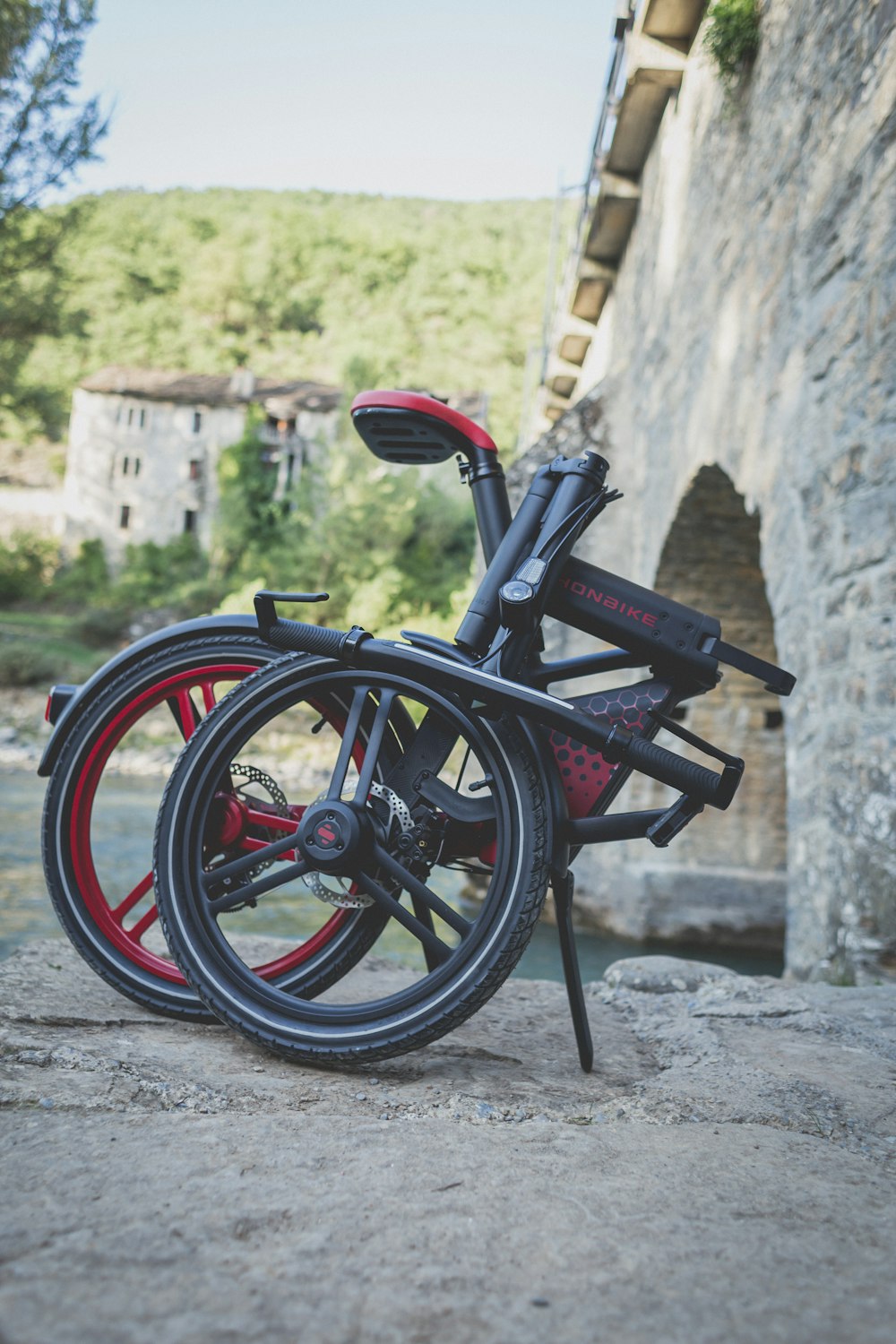 a bicycle parked by a stone wall