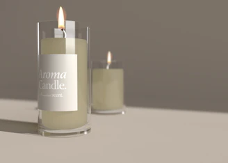Close-up of a beautifully crafted aromatic candle glowing softly on a wooden table surrounded by natural elements.