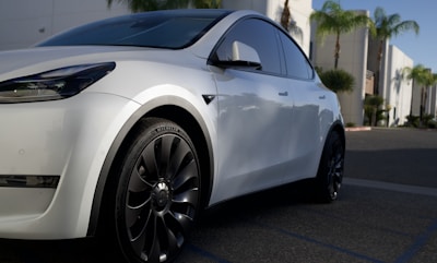 A sleek, modern rental car parked in a sunny urban setting, ready for a new journey.