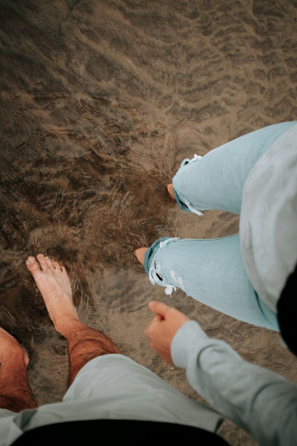 a pair of feet on a beach