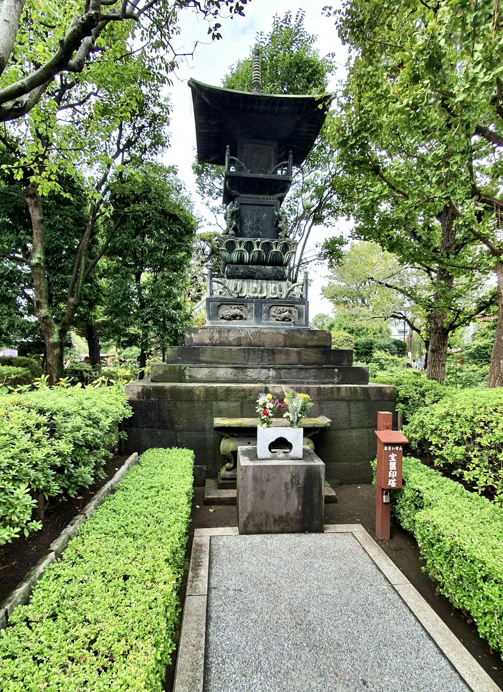 a stone monument with flowers