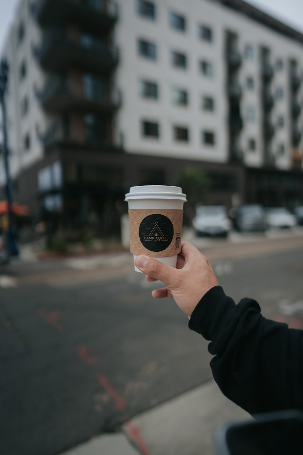 a person holding a coffee cup