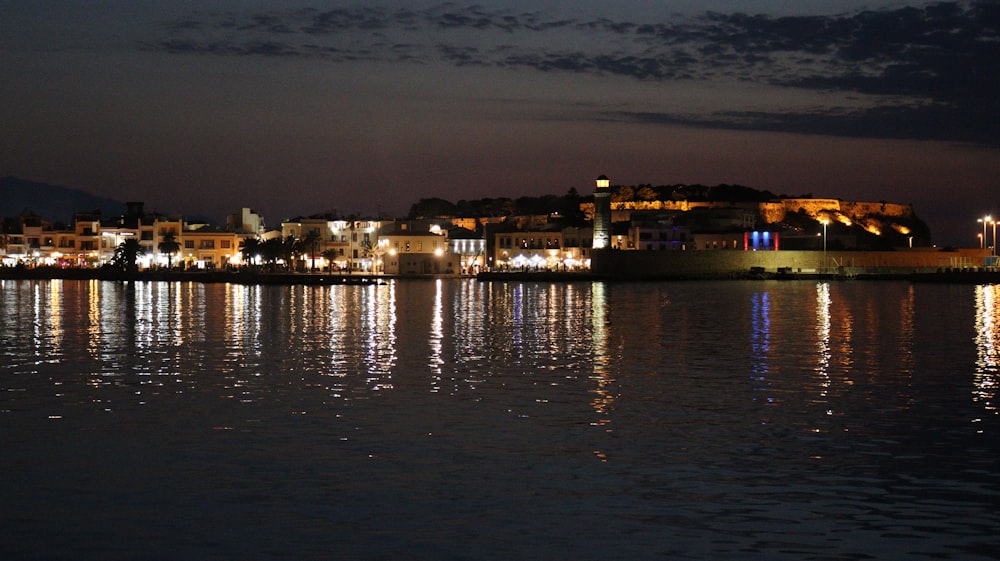 a city next to a body of water at night