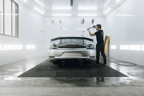 a person standing next to a car