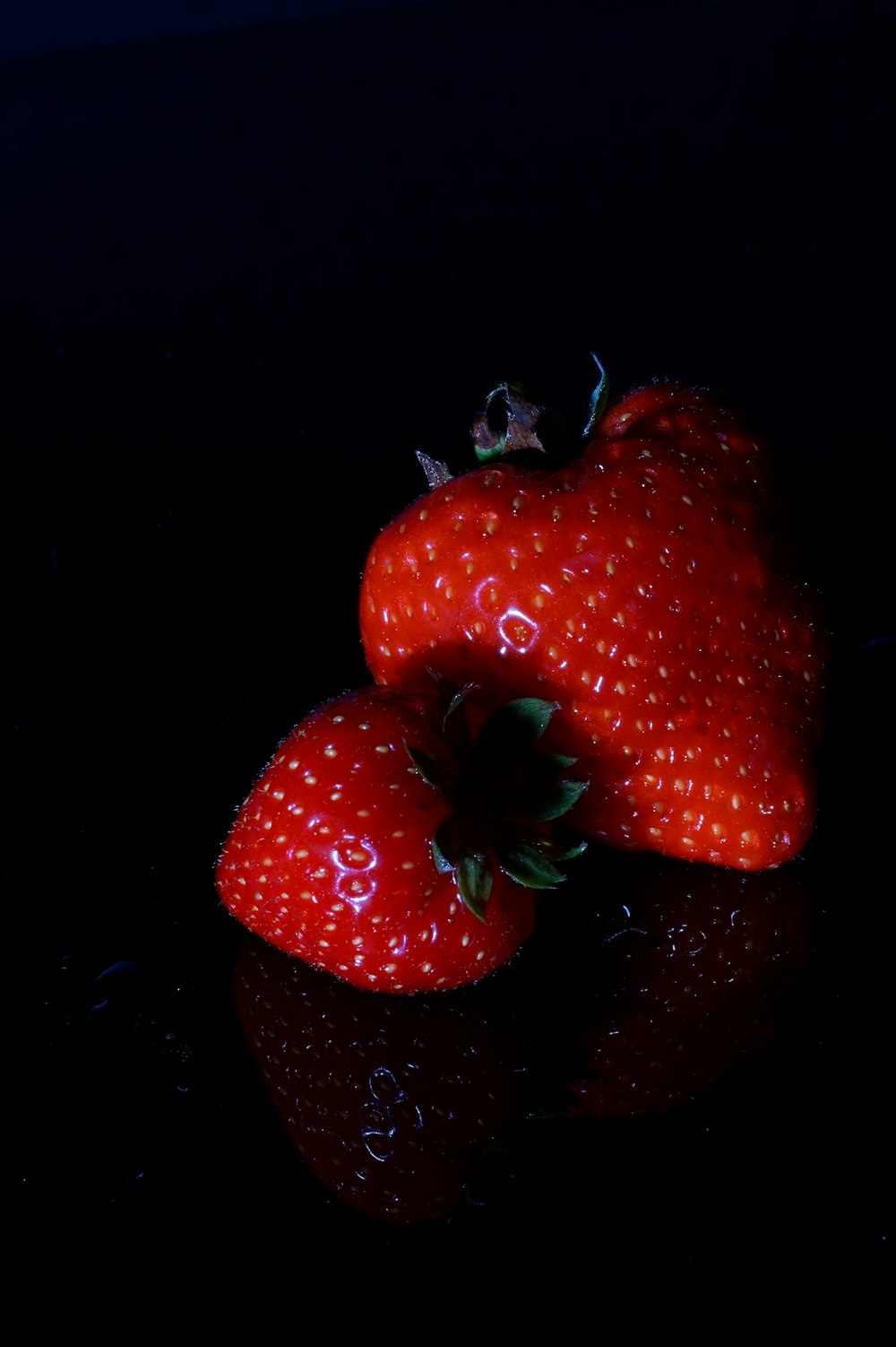 a pair of red strawberries