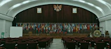A scenic shot of a global conference venue adorned with flags representing partner organizations.
